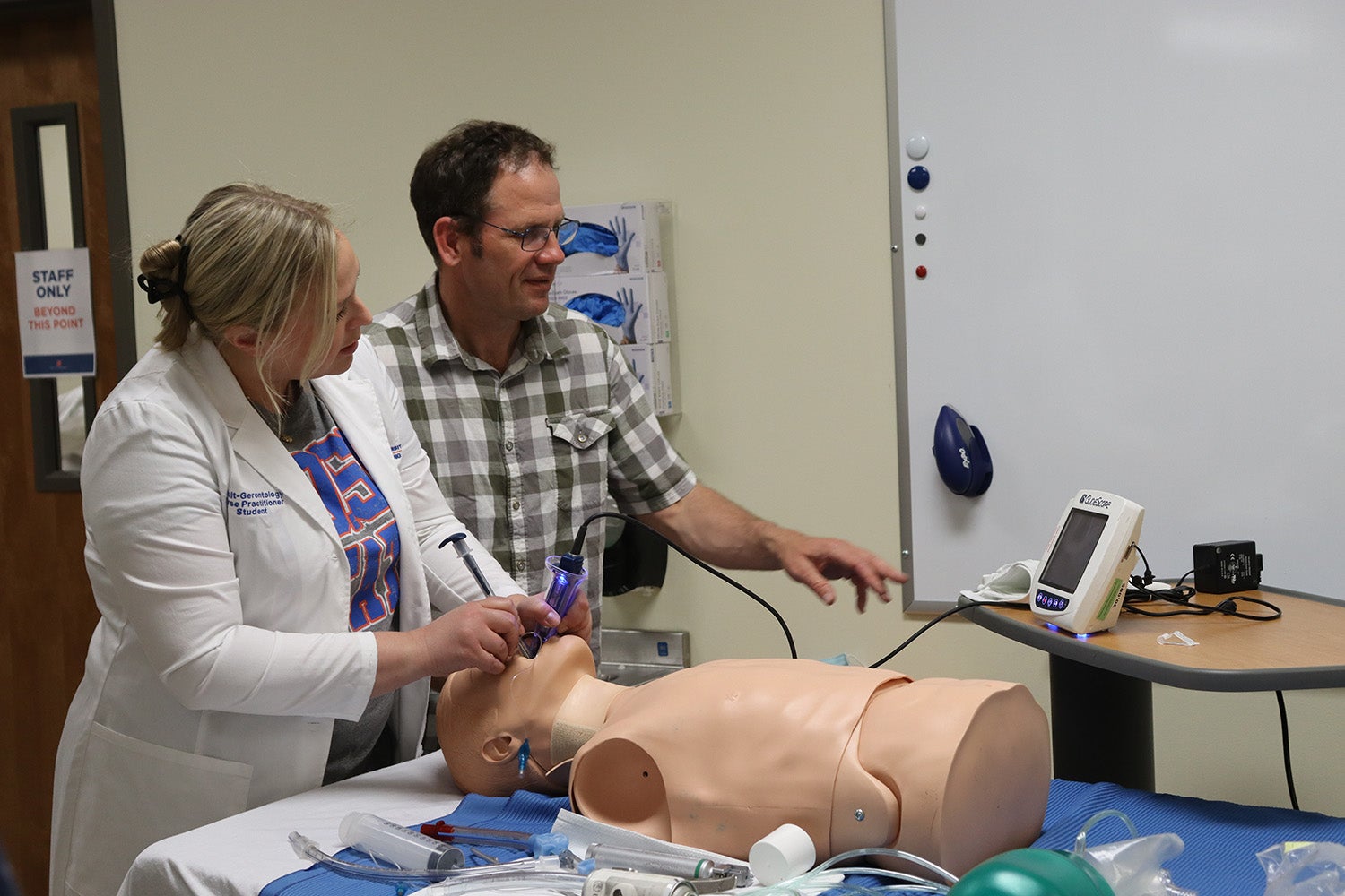 Nurse practitioner students with a mannekin
