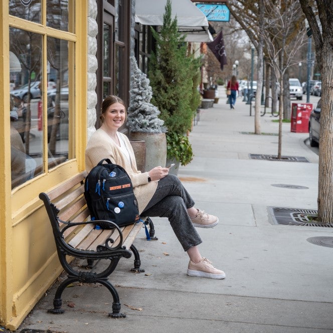 Makayla Tolman sitting on bench