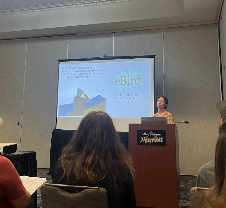 Student at a podium presenting research at the RRF conference