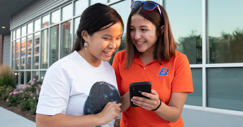 Two students looking at a phone